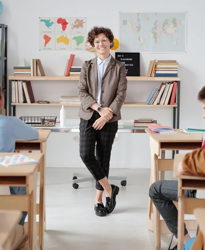 A teacher standing confidently in a classroom